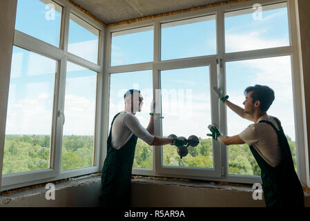 Two workers are installing windows Stock Photo