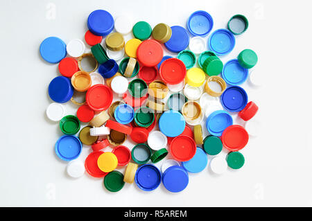 Plastic bottle caps on a white background. View from above. Stock Photo