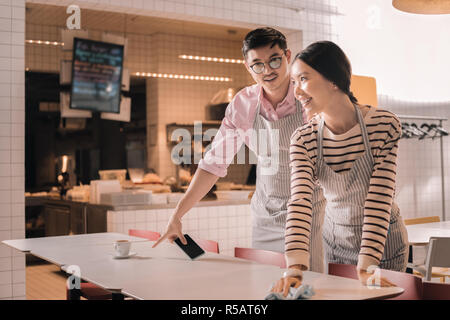 Young couple working part time job as waiters in the restaurant Stock Photo
