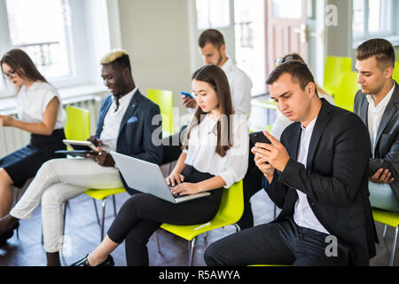 Group of business people sitting in office waiting for job interview. Conference or training concepts Stock Photo