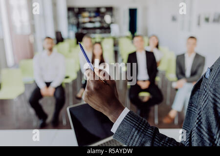 Business conference. Business meeting. Business people in formalwear discussing something while sitting together at the table Stock Photo
