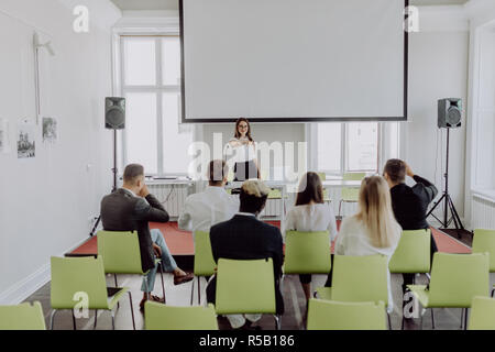 Successful businesswoman giving presentation to business team, female ceo leader coaching teaching on corporate training, woman boss talking planning  Stock Photo