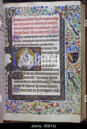 Historiated initial with the Virgin and Child on a crescent combined with a three-sided bar border and a full border with acanthus leaves, flowers, birds, a musician angel, and a coat of arms. Book of Hours, Use of Tournai, imperfect. Netherlands, S. (Ghent-Tournai area), 2nd quarter of the 15th century. Source: Harley 2433, f.25. Language: Latin and Dutch. Stock Photo