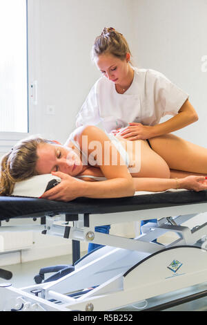 Structural osteopathy session in a pregnant woman. Stock Photo