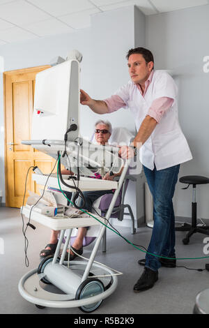 Medical consultation in a telemedicine practice in rural area, Patient assisted by a nurse for remote consultation with the general practitioner, Medi Stock Photo