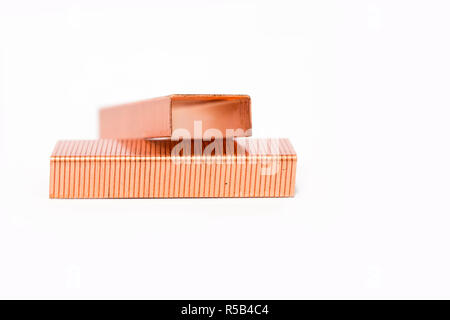 Metal staples of copper for stapler, in insulation with white background. Close up. Macro. selective focus Stock Photo