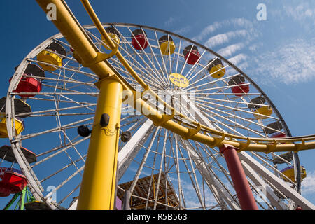 Los Angeles, CA / USA - 24 Oct 2014: Looking up at the colorful Ferris Wheel and roller coaster on the famous Santa Monica Pier in Los Angeles Stock Photo