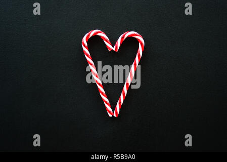 Heart made from candy canes on blackboard Stock Photo