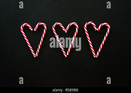 Heart made from candy canes on blackboard Stock Photo