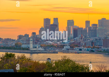 Canada, Quebec, Montreal, Downtown from Jacques Cartier Bridge across Saint Lawrence River or Fleuve Saint-Laurent, St. Helen's Island or Ile Sainte-Helene in foreground Stock Photo