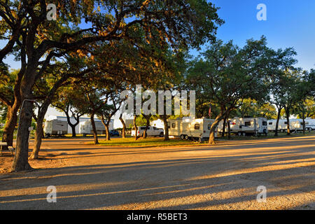 RVs and oaks in the Roadrunner RV Park, Johnson City, Texas, USA Stock Photo