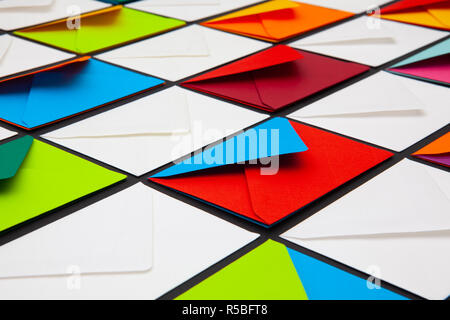 Composition with white and colored envelopes on the table. The photo suitable for various holidays and anniversaries. Stock Photo