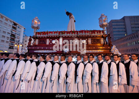 Religious float being carried through the streets during Semana Santa, (Holy Week) celebrations, Malaga, Andalucia, Spain Stock Photo