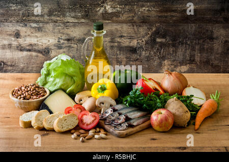 Healthy eating. Mediterranean diet. Fruit,vegetables, grain, nuts olive oil and fish on wooden table Stock Photo
