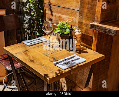 Table in the restaurant in the open air with glasses of wine. Stock Photo