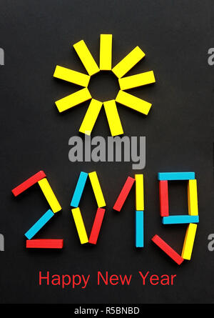 Happy New Year 2019, modern greeting card with a sun and the numbers laid with multi colored wood blocks Stock Photo
