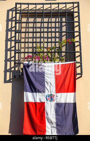 Dominican Republic, Santa Domingo, Colonial zone, Dominican flag hanging from window of Colonian house Stock Photo