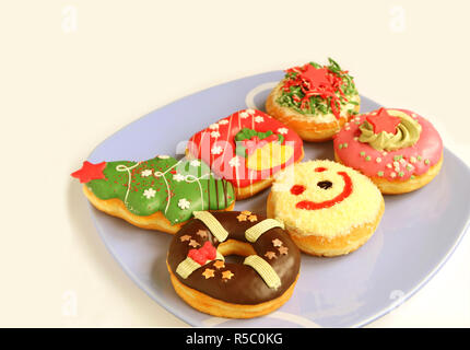 Various Design of Colorful Christmas Decorated Doughnuts Sweets on Light Blue Plate with Free Space for Text or Design Stock Photo
