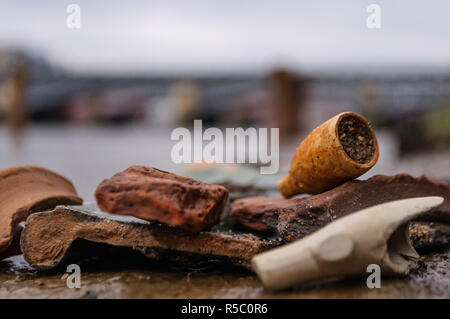 Close up of an old broken clay pipe from the past, found while mudlarking on the River Thames in London, England Stock Photo