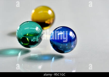 Marbles at close up photo with reflections and shadows.