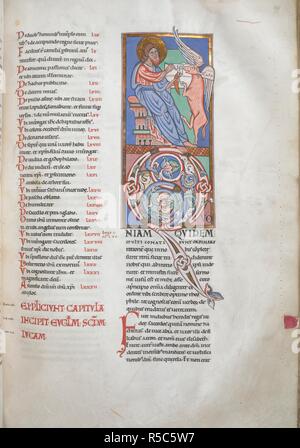 Opening of St. Luke's gospel. Initial 'Q' with acanthus decoration. Above, St. Luke is seated before a winged ox standing on its hind legs and holding a book between its forefeet. The evangelist is writing the initial verse with a quill, and has an ink-horn in his left hand. Worms Bible. Germany [Frankenthal, near Worms, Middle Rhineland]; 1148. Source: Harley 2804, f.199. Language: Latin. Stock Photo