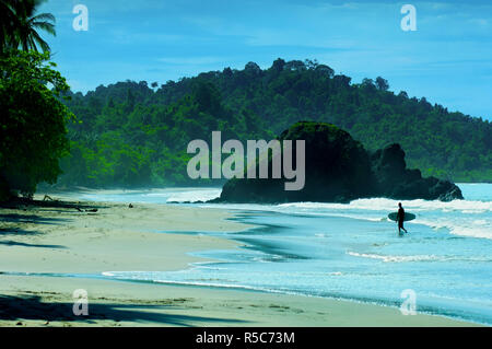Costa Rica, Quepos, Manuel Antonio, Beach, Rainforest, Pacific Ocean, Surfer Stock Photo