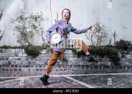 Moving and posing. Blonde-haired slim stylish photo model wearing stylish clothes moving while posing Stock Photo