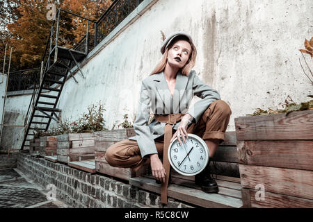 Posing for magazine. Blonde-haired slim trendy photo model with dark lips posing for magazine Stock Photo