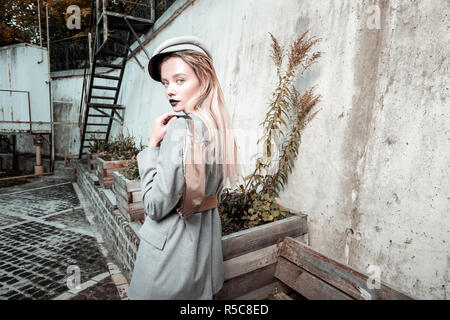 Extremely appealing. Young extremely appealing blonde-haired photo model posing for clothes promotion Stock Photo