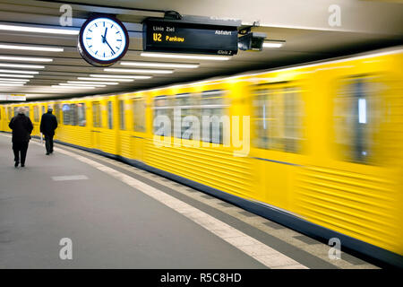 Germany, Berlin, modern subway station, moving train pulling into the station Stock Photo