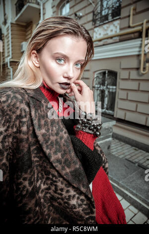 Working outside. Professional blonde-haired photo model showing nice poses while working outside Stock Photo