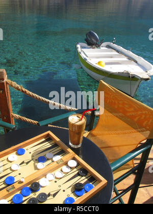 A Tavli board and Frappe. (Iced Coffee drink) Loutro, South Crete, Greece Stock Photo