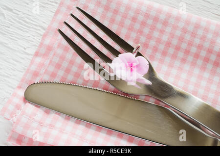 Spring table settings with fresh flower, napkin and silverware. Holidays background. Selective Focus. Stock Photo