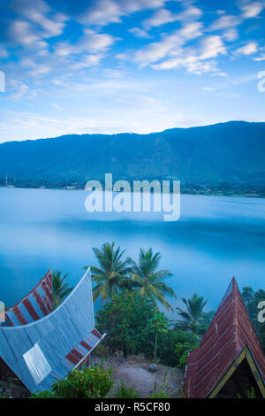 Indonesia, Sumatra, Samosir Island, Tuk Tuk, Typical Batak houses overlooking Lake Toba Stock Photo