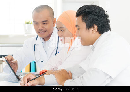 Asian doctors discussing at hospital office. Stock Photo