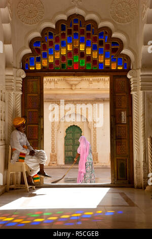 View through doorway of woman sweeping, Meherangarh Fort, Jodhpur, Rajasthan, India Stock Photo