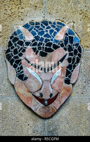 Mosaic gargoyle looking like a devil as waterspout on wall in Nice France Stock Photo