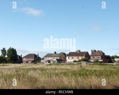 Stock Photo - back of houses in a field in summer light wivenhoe essex england uk Stock Photo