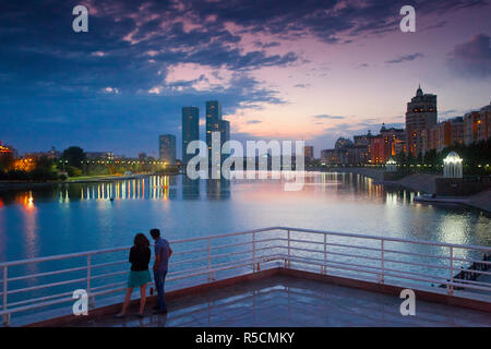Kazakhstan, Astana, Couple looking at city view from banks of Ishim River Stock Photo