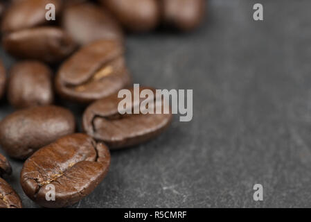 Coffees bean isolated on a slate background with shallow depth of field. Love coffee concept Stock Photo