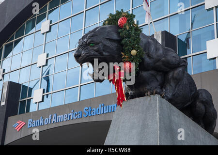 CHARLOTTE, NC - December 12, 2015: A Christmas wreath adorns a giant panthers statue outside Bank of America Stadium, home of the Carolina Panthers. Stock Photo