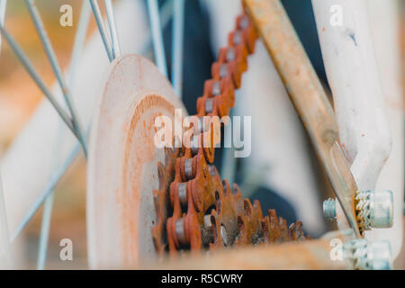 Old rusty chain on white bicycle Stock Photo