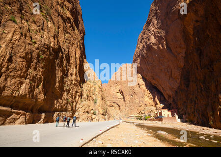 Restaurants & hotels sit underneath overhanging cliffs in the dramatic Todra Gorge, Todra Gorge, Morocco Stock Photo