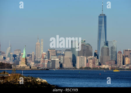 A view of three of New York City's landmarks from across the Hudson River; the Statue of Liberty, the  Empire State Building, and the Freedom Tower. Stock Photo