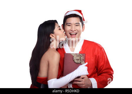 Woman give kiss to man in santa claus costume Stock Photo