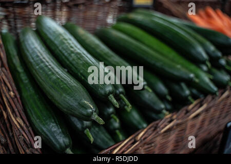 fresh green cucumbers in a wicker net Stock Photo