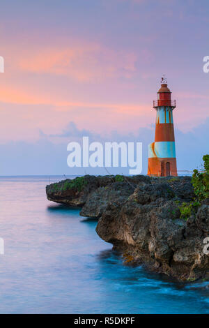 Folly Point Lighthouse illuminted at dusk, Port Antonio, Portland Parish, Jamaica, Caribbean Stock Photo