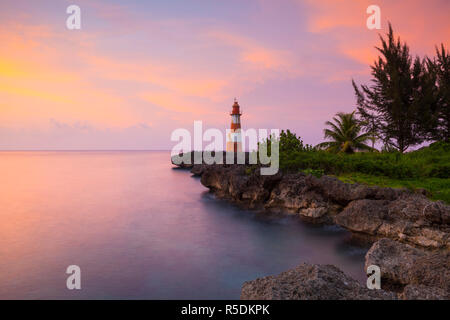 Folly Point Lighthouse Illuminated at Sunset, Port Antonio, Portland Parish, Jamaica, Caribbean Stock Photo