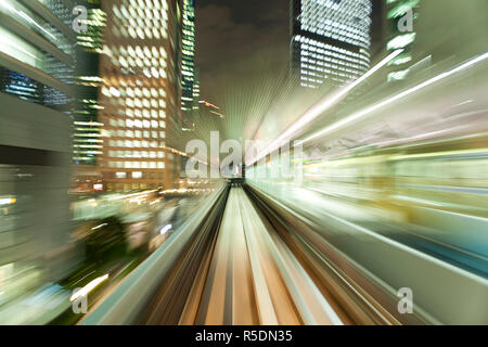 Asia, Japan, Honshu, Tokyo, POV blurred motion of Tokyo buildings from a moving train Stock Photo