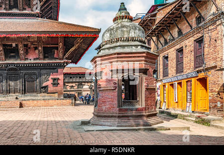 Bhaktapur, Nepal - Oct 12, 2018: Tourists visiting Bhaktapur Durbar Square in Nepal, the 55 Window Palace at at the background. Stock Photo